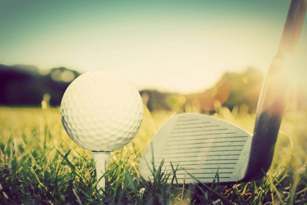 golf ball tee on grass