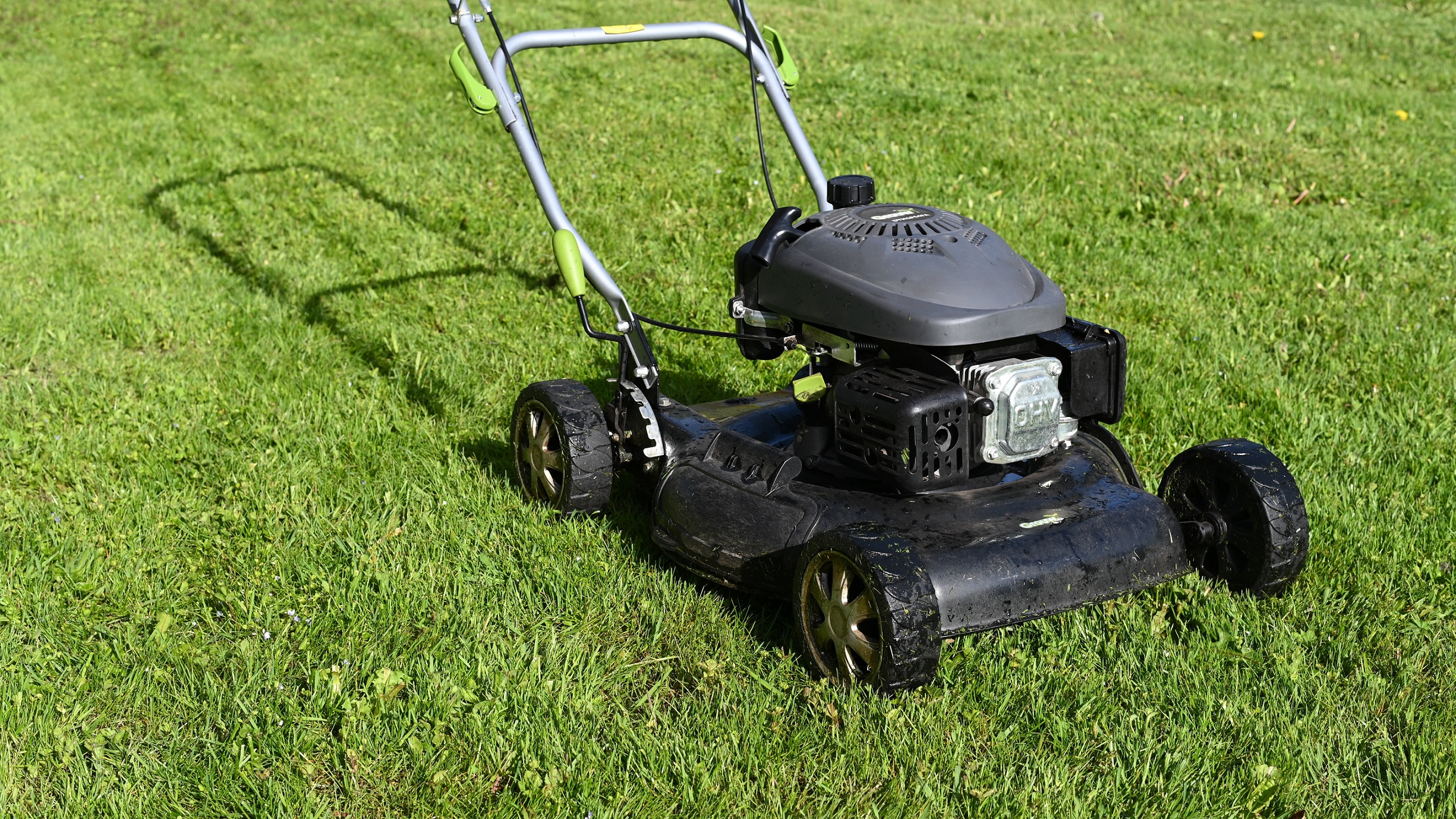 black lawnmower on grass